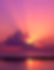 Sunbeams behind clouds in vivid sunset sky reflecting in ocean water