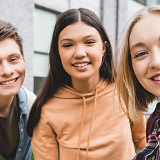 Smiling students outside school