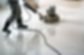 Photo of a man cleaning the floor with a cleaning machine