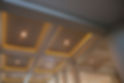 Close-up of a ceiling with recessed lights and warm LED accent lighting