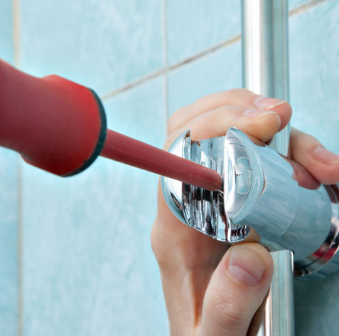 Worker fitted a shower head holder
