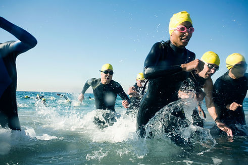 Swimmers running out of the water
