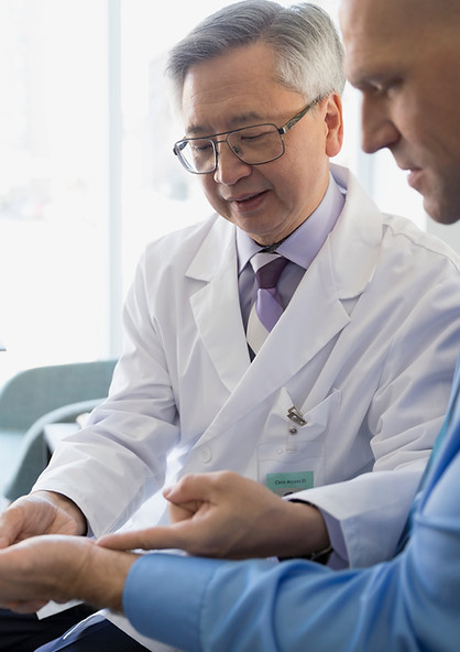 Male doctor checking a man's wrist