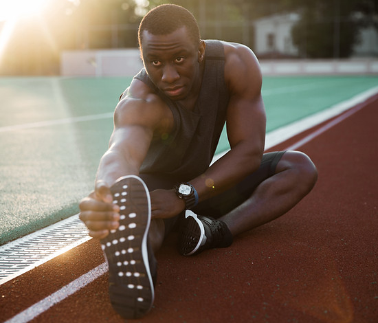 Athlete Stretching Legs