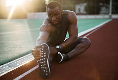 Athlete Stretching Legs