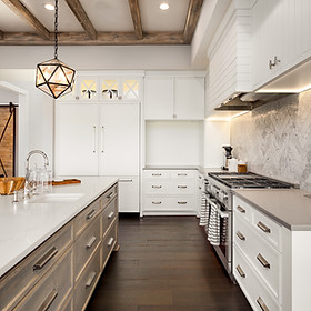 A modern kitchen with white wooden cabinets
