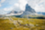 Scenic view of the awe-inspiring Dolomite mountains under a cloud-kissed sky, symbolizing the transformative power of nature as explored in Dr. Heidi Schreiber-Pan's blog on spirituality and mental health.