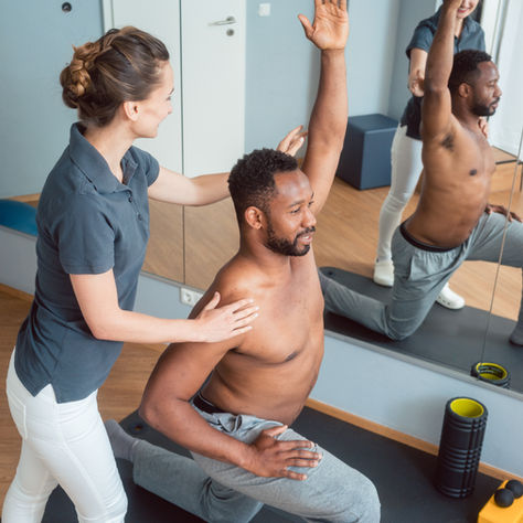 Physiotherapist helping patients exercise in the clinic
