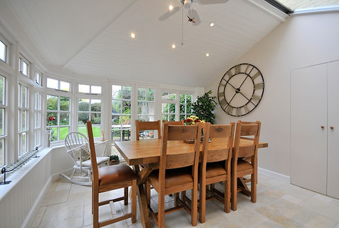 A living room with white walls and a wooden table