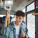Happy Asian man riding a bus