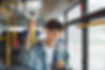 Happy Asian man riding a bus