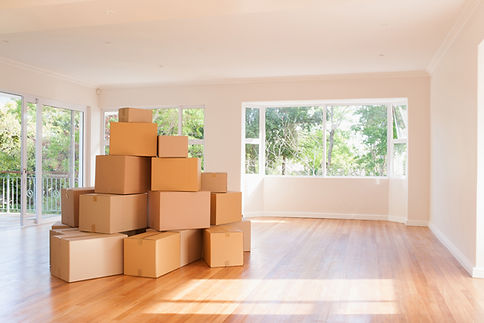 Boxes stacked in living room of new house