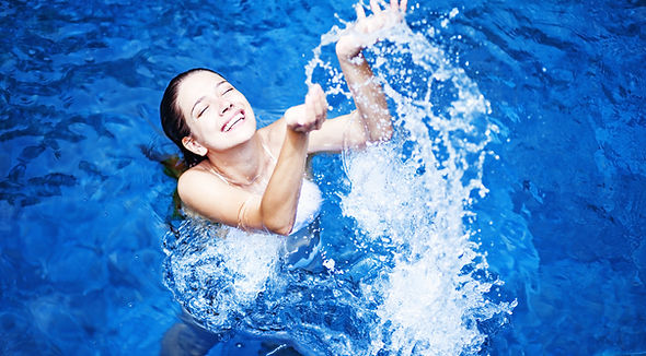 hapy woman in pittsburghpa swimming in her inground swimming pool that revelatin plumbing repaired