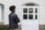 Professional performing home inspections outside a house.