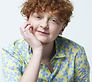 Curly-haired Person Smiling