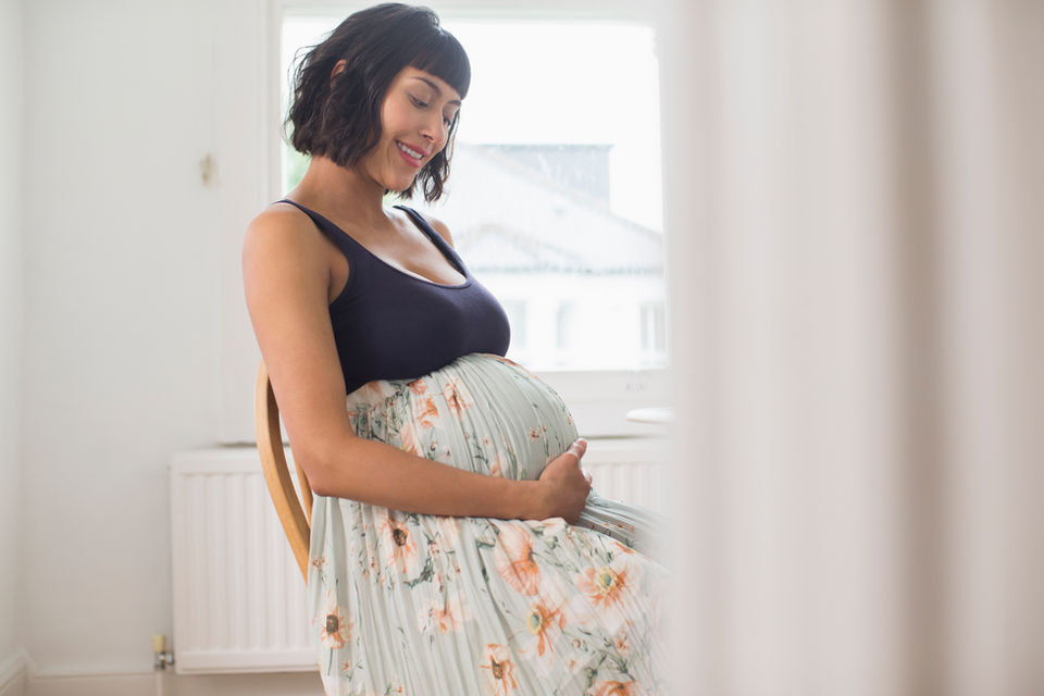 Maternity Photography by Blake Ferguson depicts a woman nurturing her Baby Bump in the at-home nursery in Ontario, Canada.