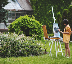 Asian girl painting in a garden