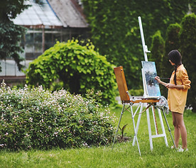 Asian girl painting in a garden