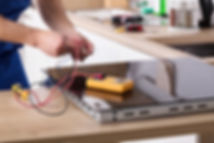 Technician Repairing Stove