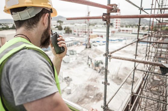 Construction worker with walkie-talkie in construction site