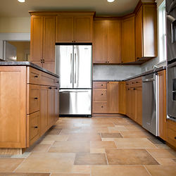A kitchen with wooden cabinets and stainless steel appliances