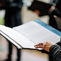 Someone holding a music book
