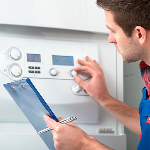 Technician servicing heating boiler