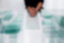 Mans hands using glass cutter on glass pane at workbench