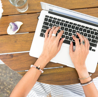A content writer typing on a laptop.