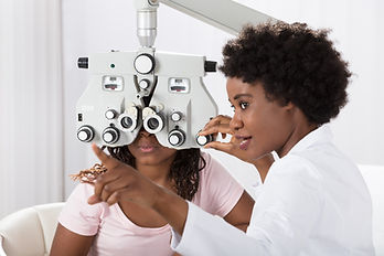 Child having eye test done by opthamologist