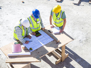 Contractor using AI scheduling software on-site to manage construction timelines efficiently