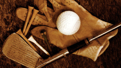 golf office desk with multiple papers, notes, and systems, slightly disorganized, person switching between tasks