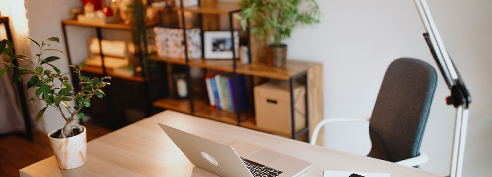 Home office desk with laptop ready for a discovery call.