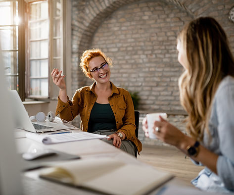 two people talking at a desk