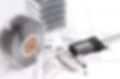 A metal finned heatsink and a digital caliper rest on technical blueprints
