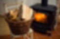 Basket of logs in front a burning fire