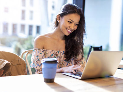 lady looking at computer and smiling