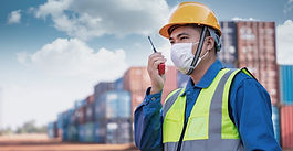 worker in hi-vis talking on walkie talkie