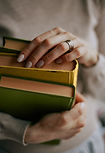 Holding Three Books