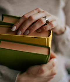 Holding Three Books