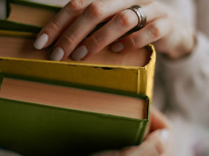 Holding Three Books