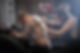 A photo of male artist tattooing man's back