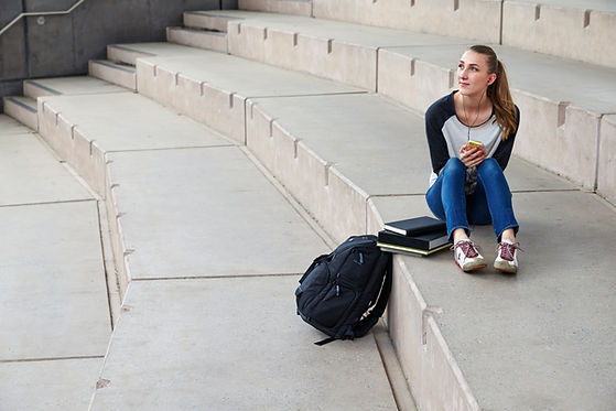 student sits at ampitheater