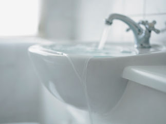Close up of overflowing bathroom sink
