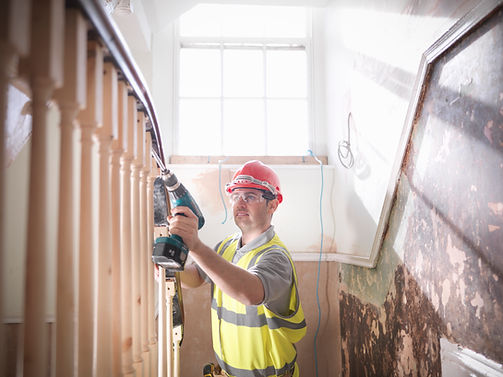 Builder renovating staircase