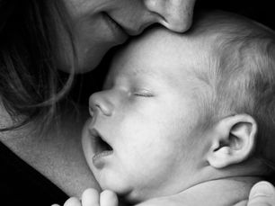A tender moment shared between a mother and her newborn, capturing the serene and intimate bond post-delivery.