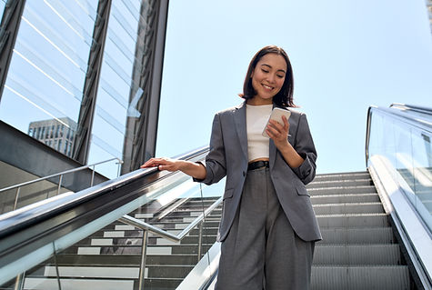 Businesswoman On Escalator