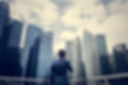 Businessman listening to the phone while looking at the skyscrapers