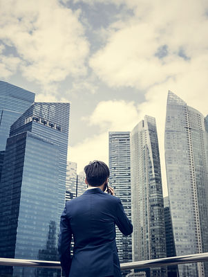 Businessman listening to the phone while looking at the skyscrapers