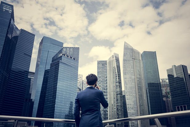 Businessman listening to the phone while looking at the skyscrapers